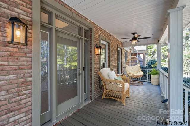a view of a balcony with chairs and wooden floor