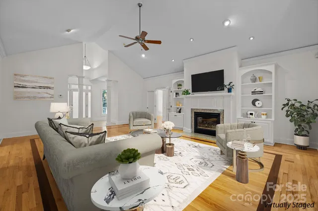 a living room with furniture a flat screen tv and a fireplace