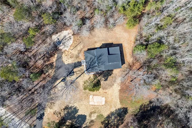 an empty room with a window and a ceiling fan