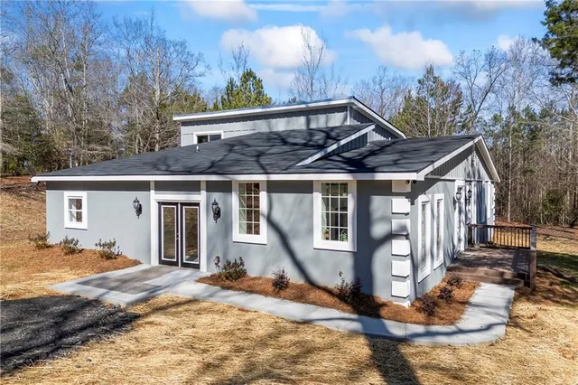 a kitchen with granite countertop stainless steel appliances a sink stove top oven and refrigerator