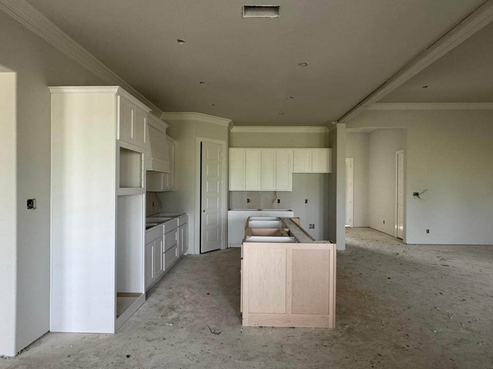 2305 Quartz Street Krum, TX 76249 - Photo 9 of 18 a kitchen with cabinets a refrigerator and a sink