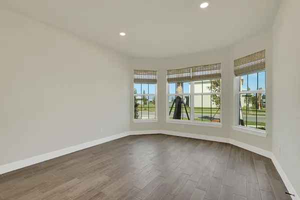 a view of an empty room and wooden floor