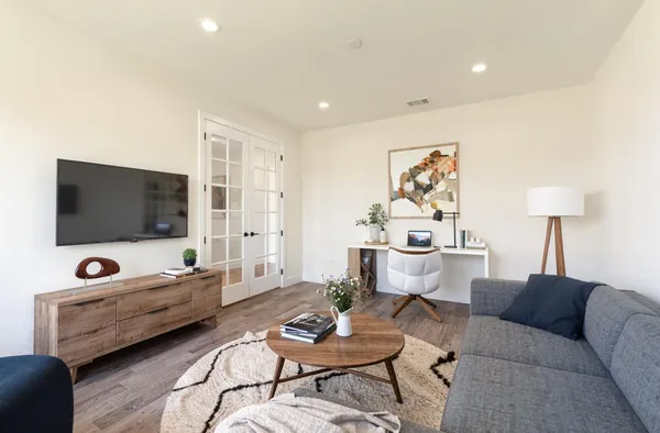 a living room with furniture and wooden floor