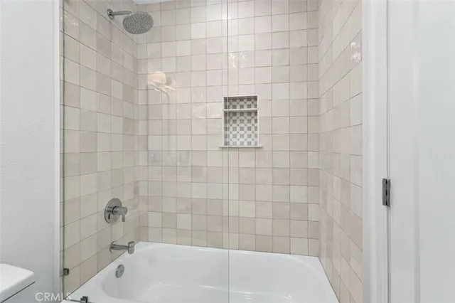 a bathroom with a bathtub and a shower