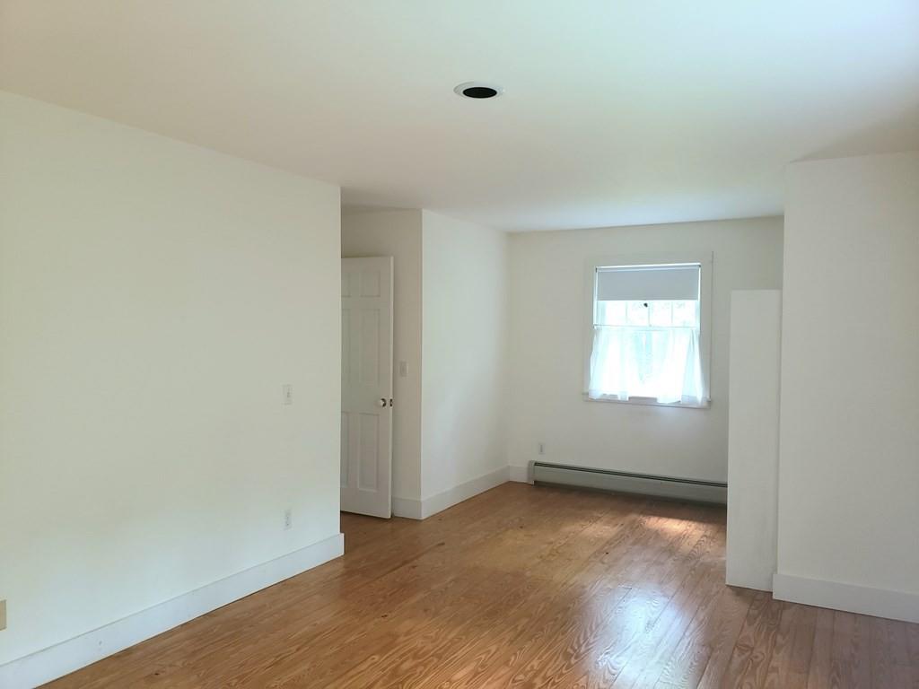 115 Audubon Road Northampton, MA 01053 - Photo 19 of 30 a view of an empty room with wooden floor and a window