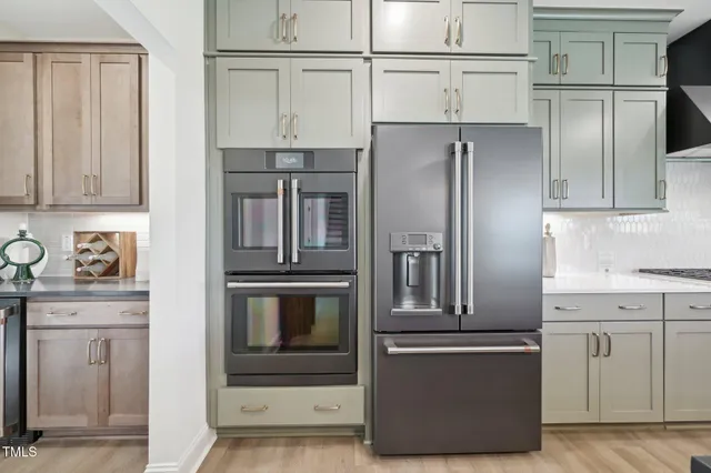 a bathroom with a sink a toilet a mirror and shower