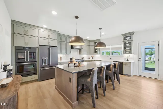 a living room with lots of furniture and kitchen view