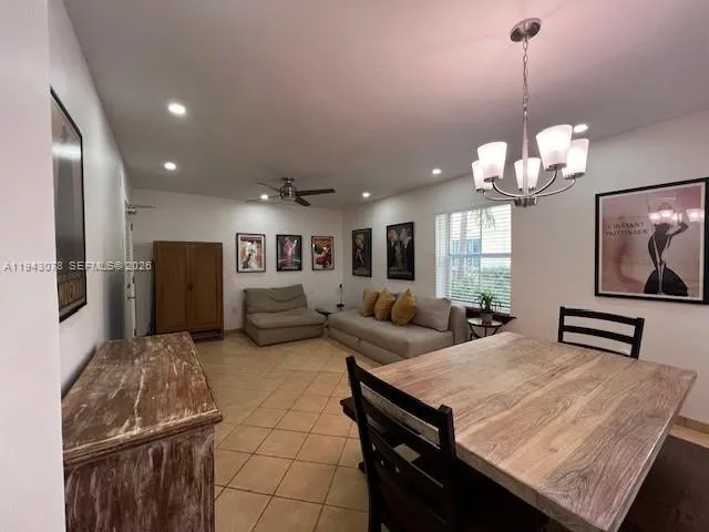 a living room with couches a dining table and chairs with wooden floor