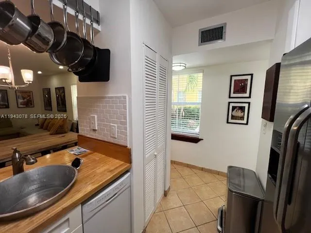 a kitchen with a sink a stove and a mirror