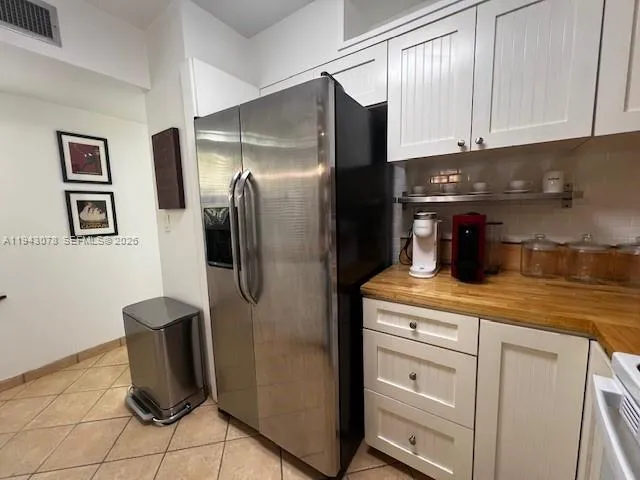 a kitchen with stainless steel appliances granite countertop a refrigerator and a stove