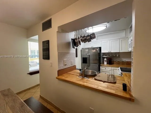 a kitchen with a refrigerator and a sink