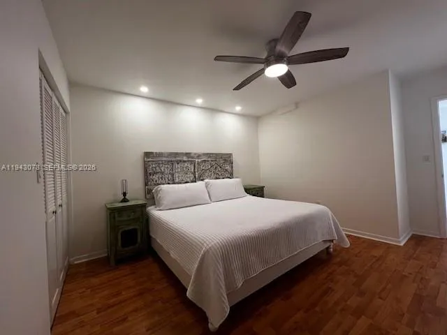a bedroom with a bed and a ceiling fan