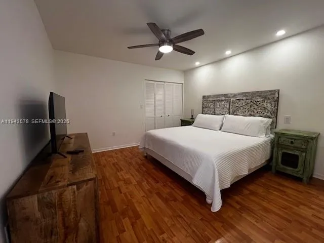 a bedroom with a bed and a ceiling fan