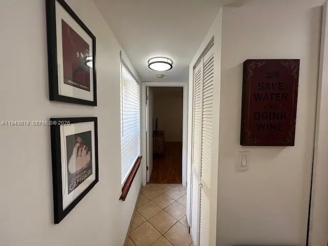 a view of a hallway to rooms and stairs
