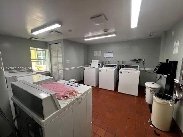 a kitchen that has a lot of cabinets a sink and a stove in it