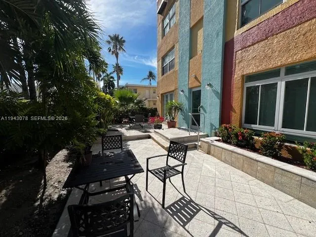 a view of a patio with table and chairs and potted plants