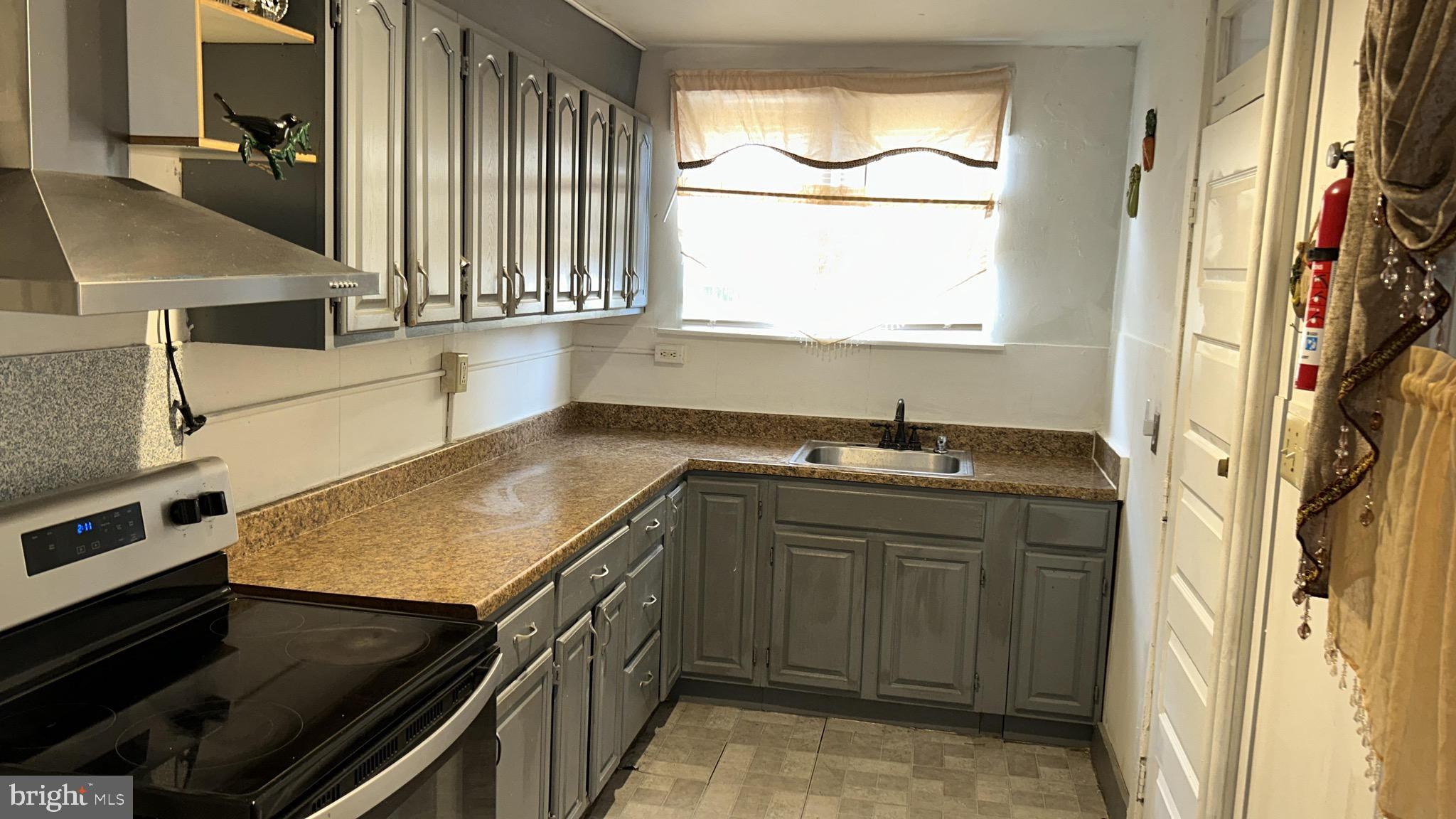 318 South 11th Street Reading, PA 19602 - Photo 21 of 21 a kitchen with a sink stove and cabinets