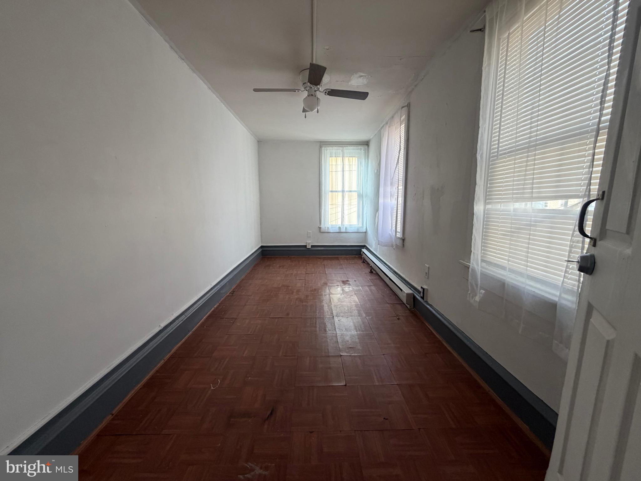 318 South 11th Street Reading, PA 19602 - Photo 9 of 21 a view of a hallway with wooden floor and a chandelier