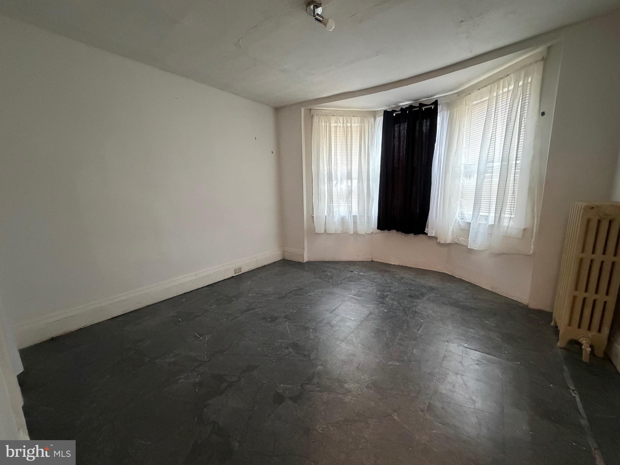 318 South 11th Street Reading, PA 19602 - Photo 10 of 21 an empty room with wooden floor and windows