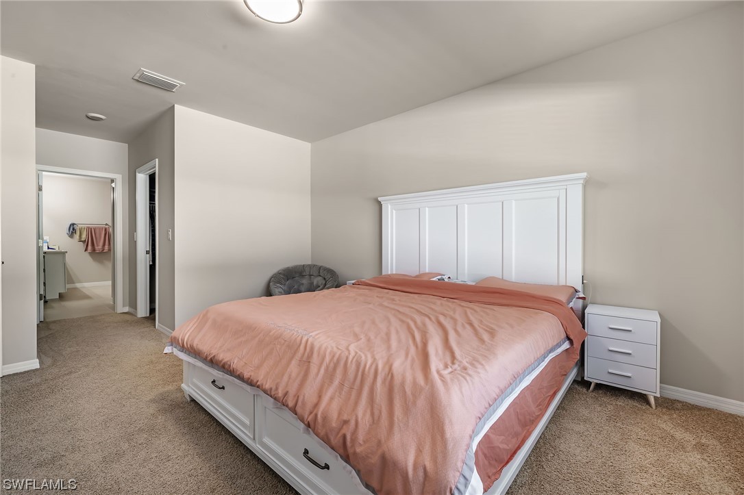 17504 Oriole Road Fort Myers, FL 33967 - Photo 13 of 23 a bedroom with a bed and walk in closet