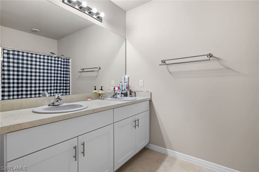 17504 Oriole Road Fort Myers, FL 33967 - Photo 14 of 23 a bathroom with a sink and a mirror