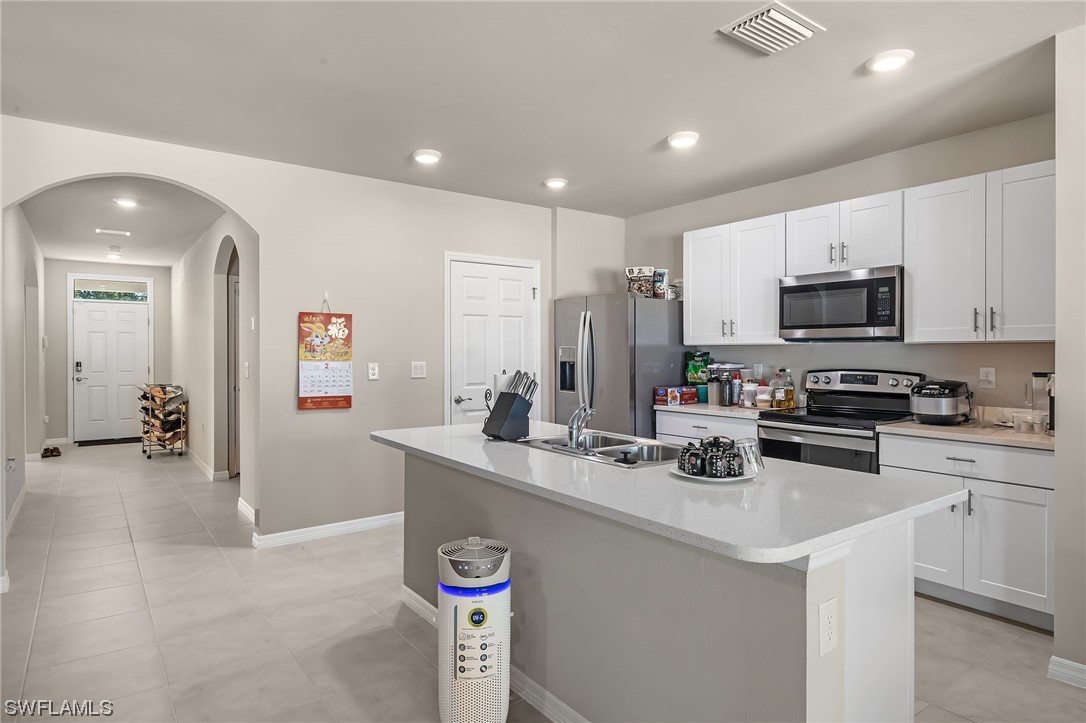 17504 Oriole Road Fort Myers, FL 33967 - Photo 2 of 23 a kitchen with a sink a stove and cabinets