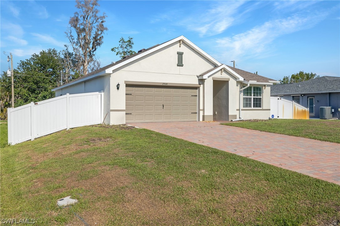 17504 Oriole Road Fort Myers, FL 33967 - Photo 22 of 23 a front view of a house with a yard and garage