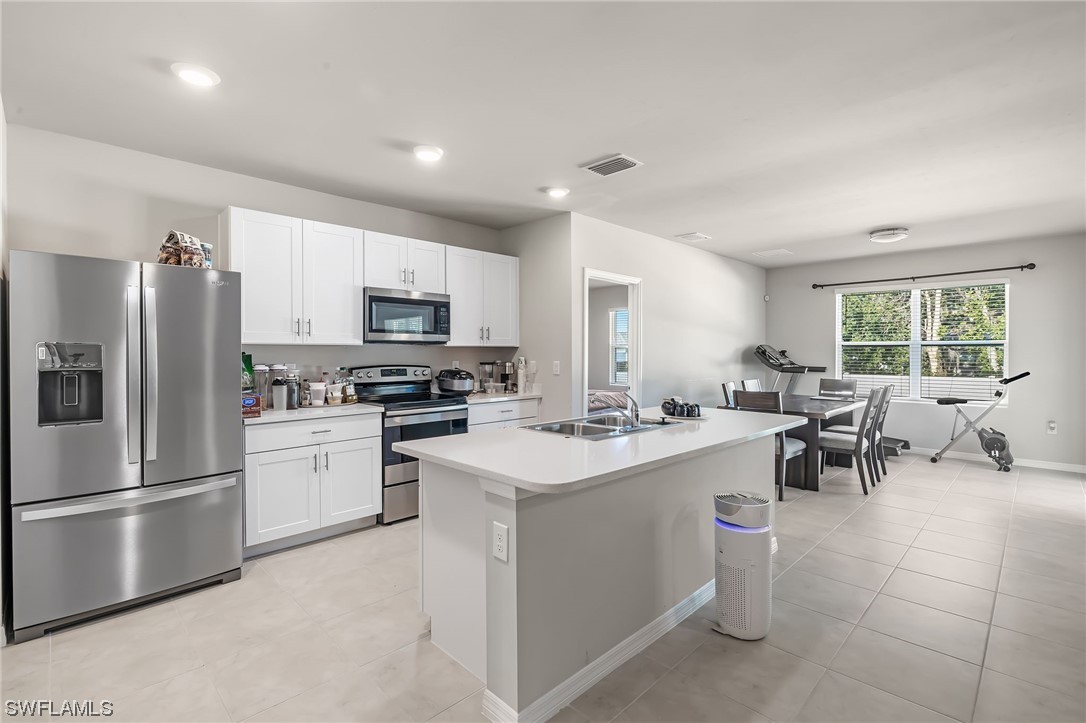 17504 Oriole Road Fort Myers, FL 33967 - Photo 3 of 23 a kitchen with a sink stainless steel appliances and cabinets