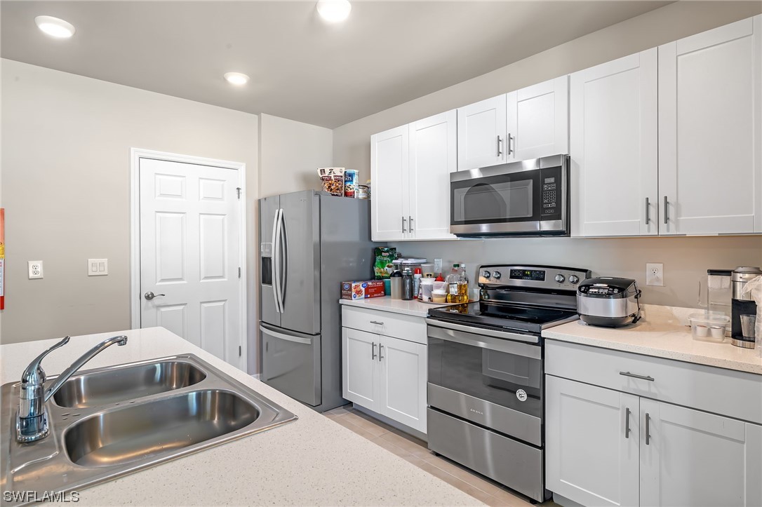 17504 Oriole Road Fort Myers, FL 33967 - Photo 6 of 23 a kitchen with a sink and steel appliances