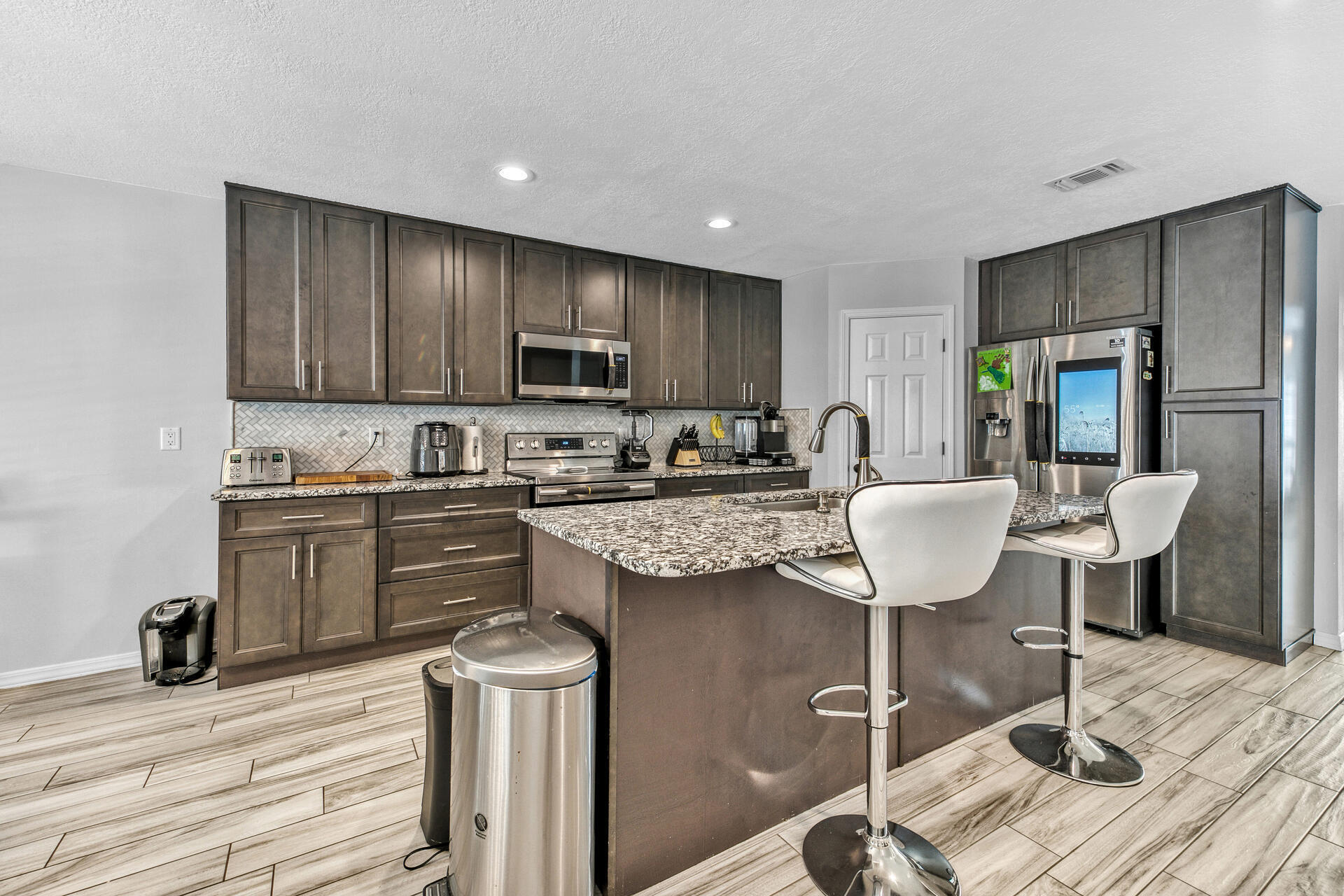 606 Risen Star Drive Crestview, FL 32539 - Photo 11 of 37 a kitchen with a stove a refrigerator and a coffee table