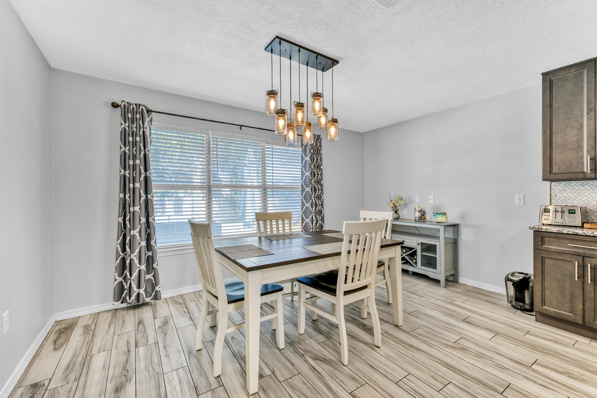 606 Risen Star Drive Crestview, FL 32539 - Photo 13 of 37 a view of a dining room with furniture a chandelier and wooden floor