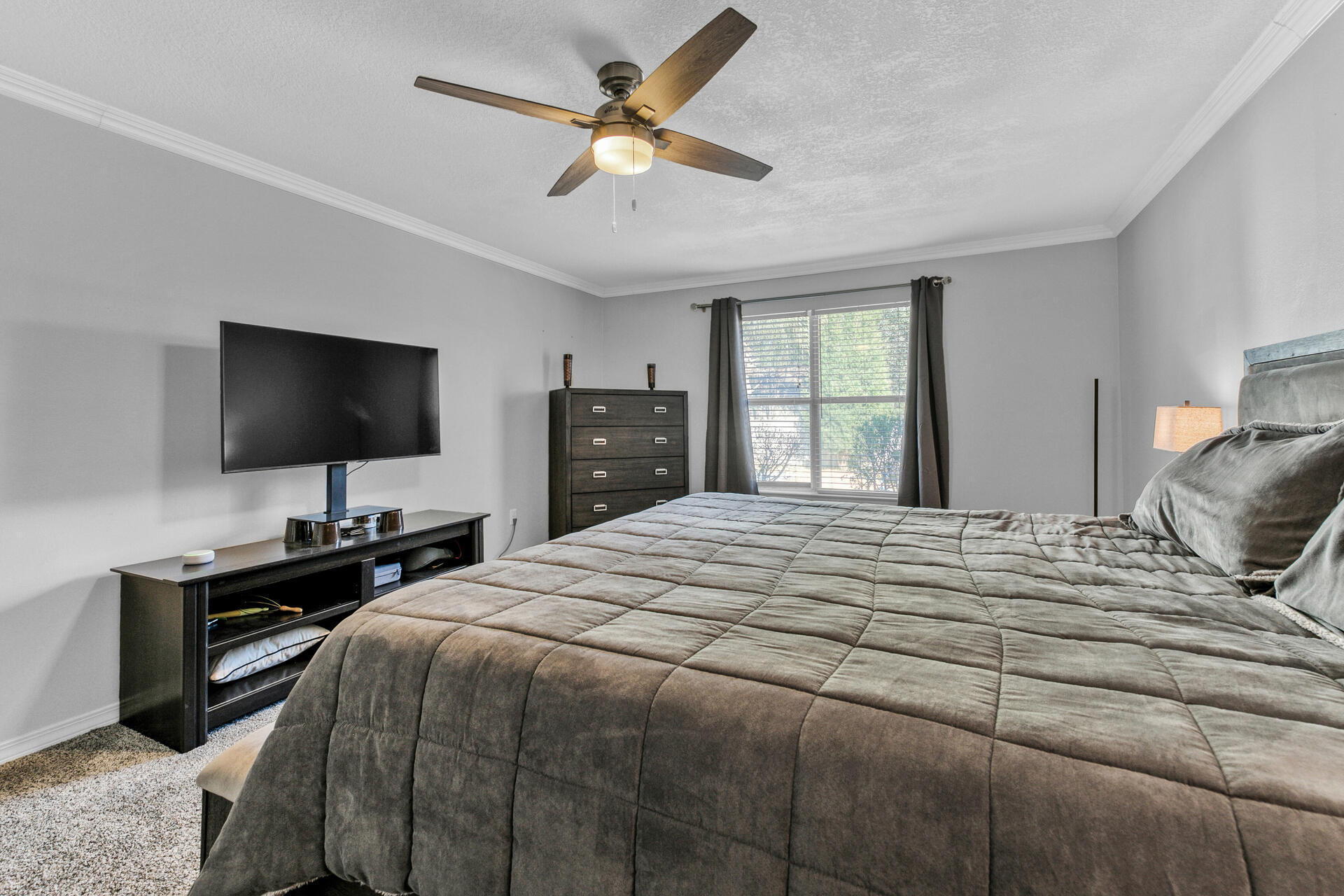 606 Risen Star Drive Crestview, FL 32539 - Photo 18 of 37 a bedroom with a bed and a flat screen tv