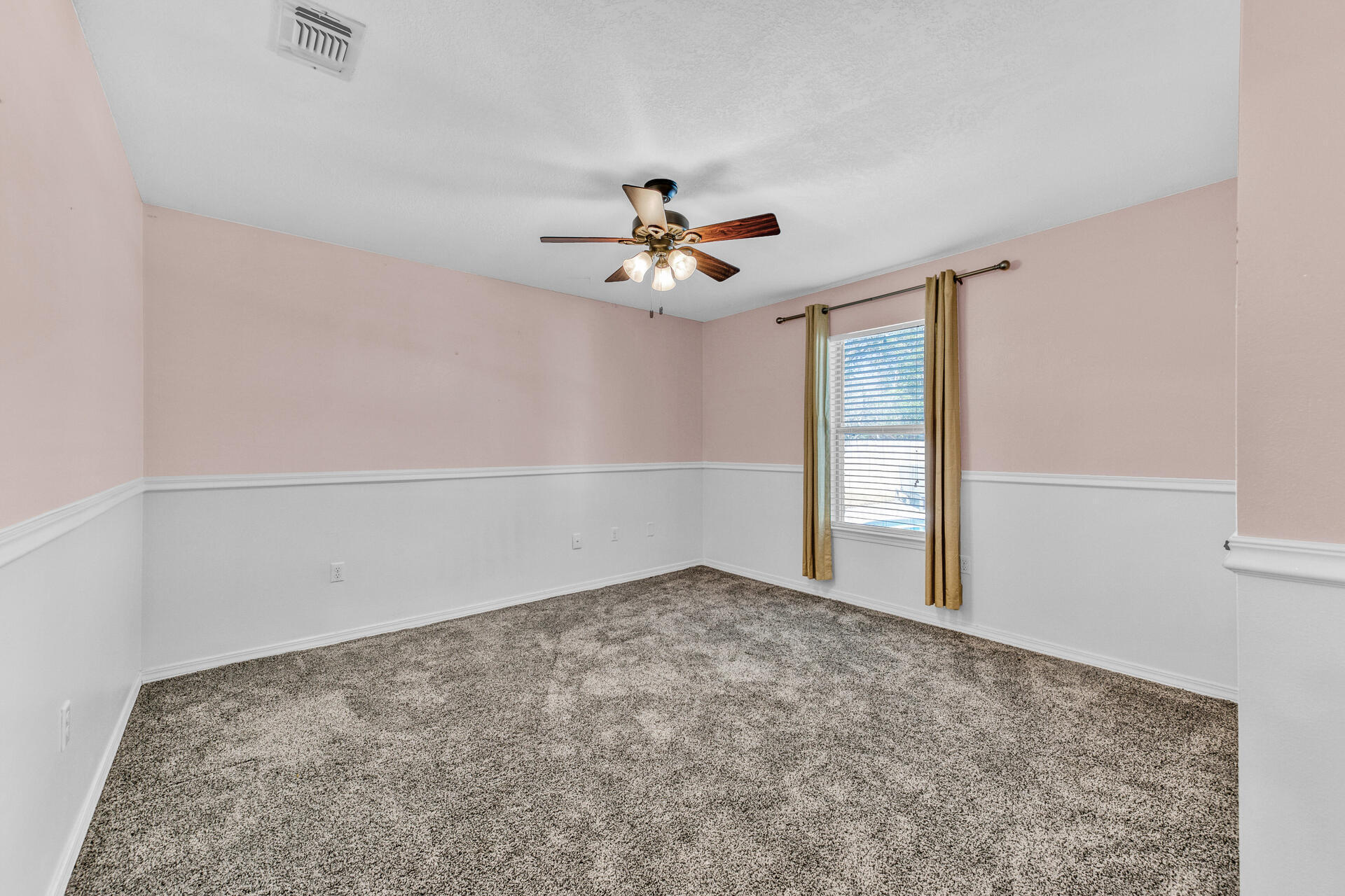 606 Risen Star Drive Crestview, FL 32539 - Photo 23 of 37 an empty room with fan and windows