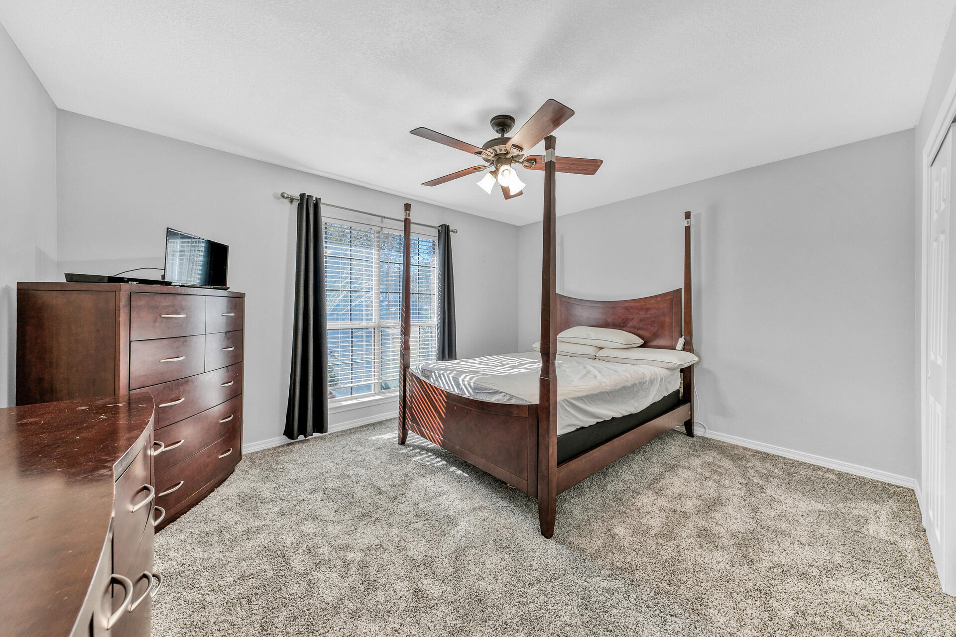606 Risen Star Drive Crestview, FL 32539 - Photo 27 of 37 a bedroom with a bed and a flat tv screen on the dresser