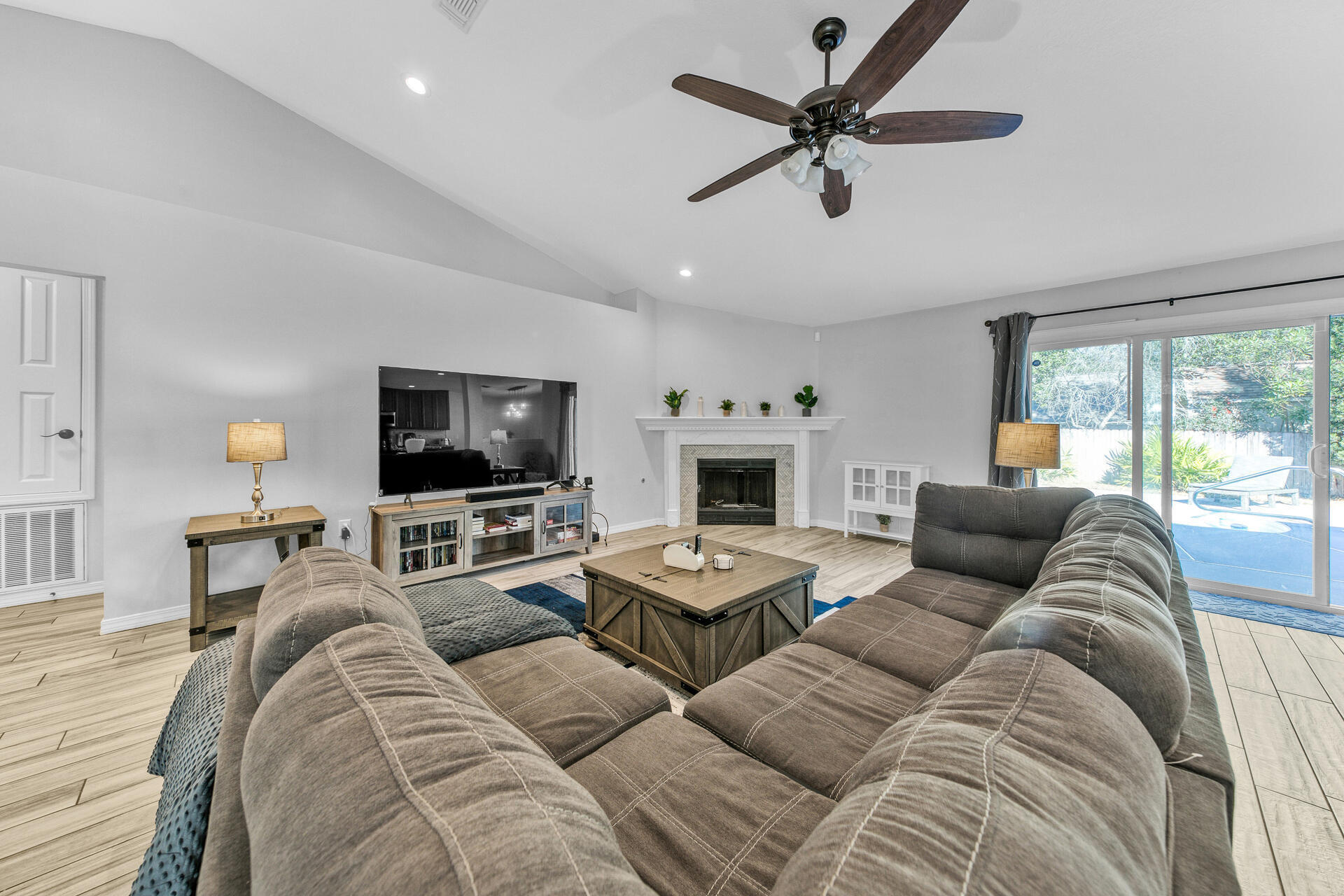 606 Risen Star Drive Crestview, FL 32539 - Photo 3 of 37 a living room with furniture a flat screen tv and a large window