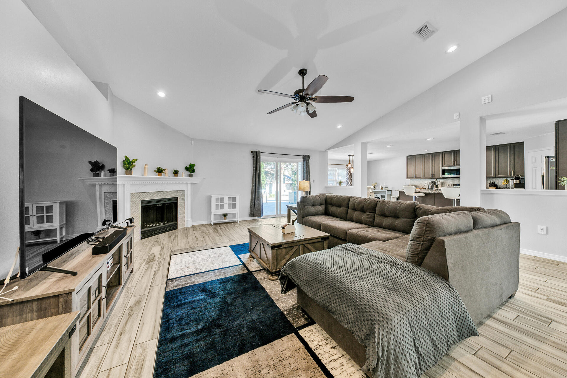 606 Risen Star Drive Crestview, FL 32539 - Photo 5 of 37 a living room with furniture a fireplace and a flat screen tv