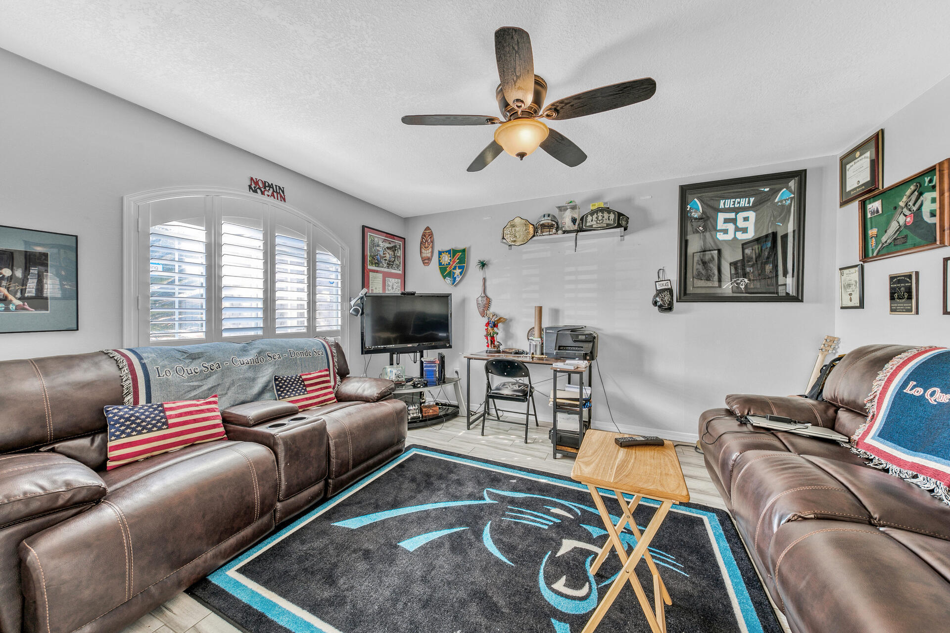 606 Risen Star Drive Crestview, FL 32539 - Photo 8 of 37 a living room with furniture a ceiling fan and a window