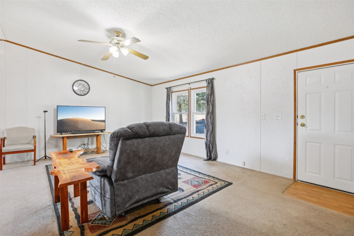 6975 Silvermine Road Harwood, TX 78632 - Photo 11 of 33 a living room with furniture and a chandelier