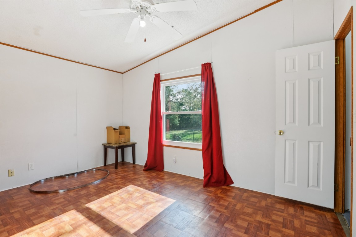 6975 Silvermine Road Harwood, TX 78632 - Photo 15 of 33 a view of a room with a ceiling fan and a wooden floor