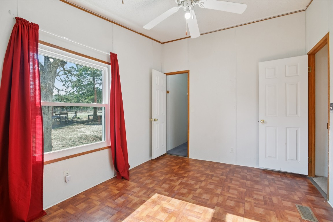 6975 Silvermine Road Harwood, TX 78632 - Photo 18 of 33 a view of a bedroom with a bed and a window