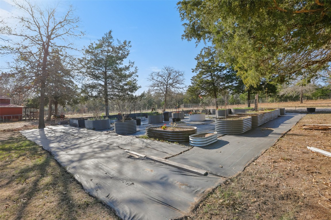 6975 Silvermine Road Harwood, TX 78632 - Photo 2 of 33 a view of a backyard with couches and a fire pit