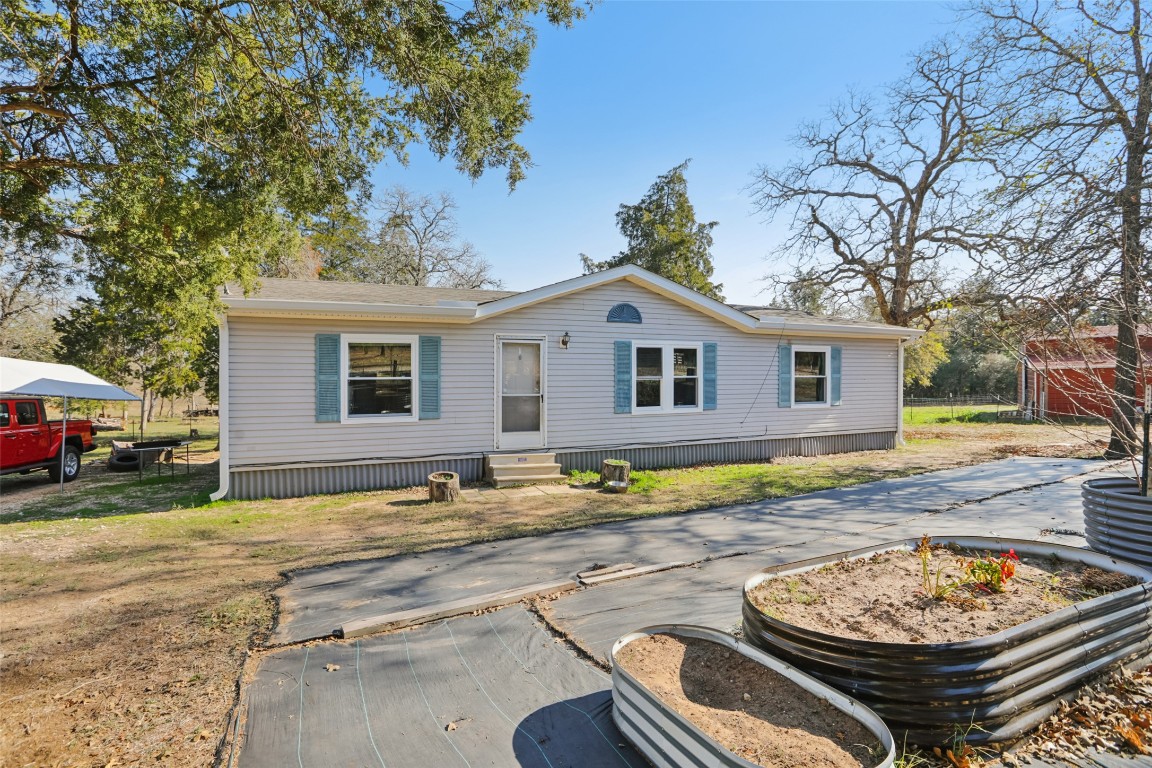 6975 Silvermine Road Harwood, TX 78632 - Photo 4 of 33 a view of a white house with a yard