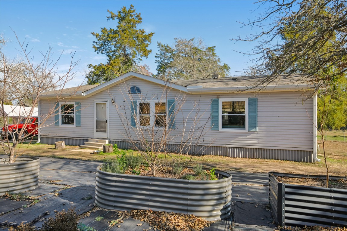 6975 Silvermine Road Harwood, TX 78632 - Photo 5 of 33 a front view of a house with garden