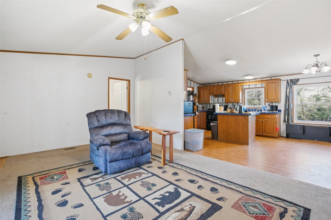 6975 Silvermine Road Harwood, TX 78632 - Photo 8 of 33 a living room with couches and kitchen view with wooden floor
