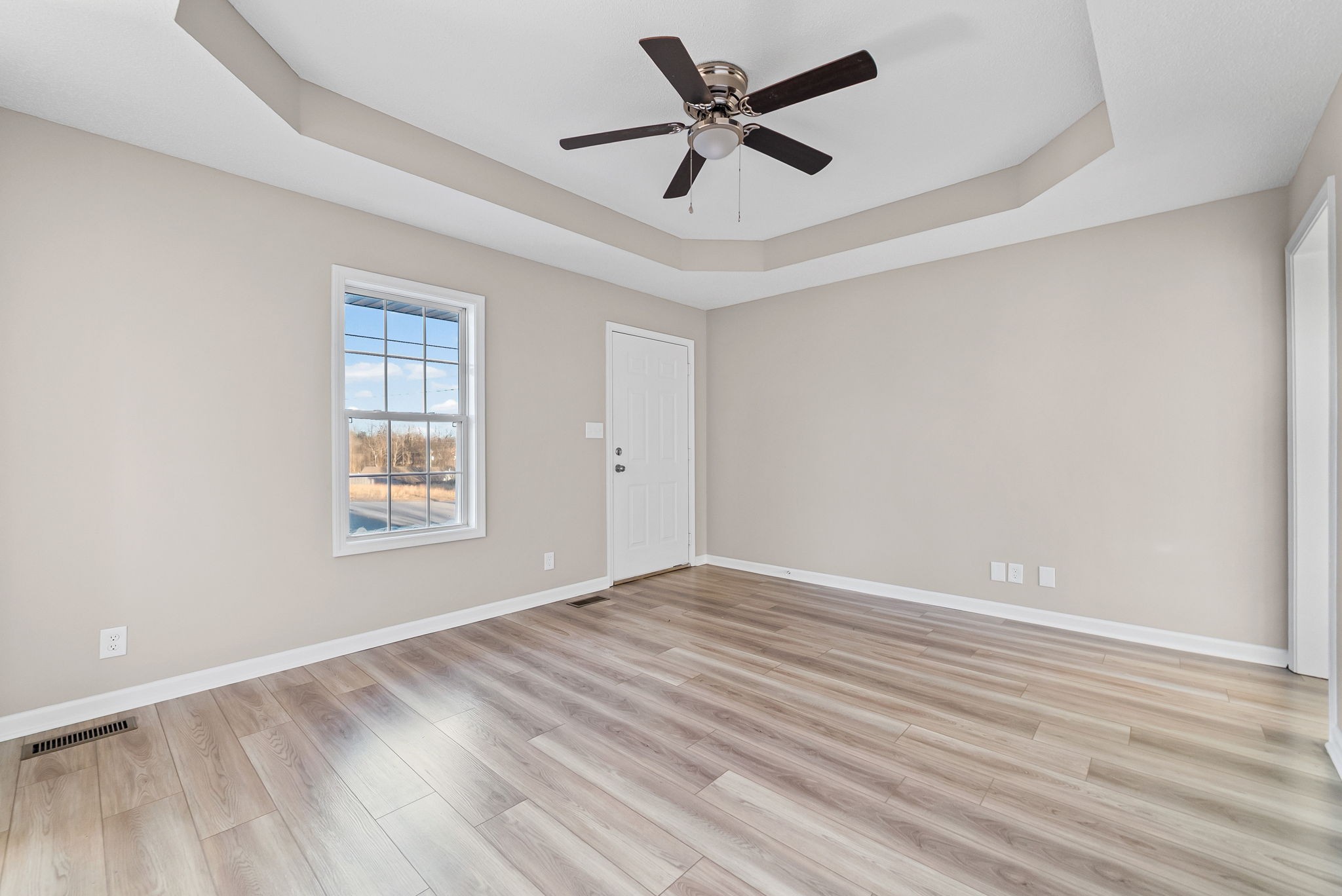 1010 Winesap Road Clarksville, TN 37040 - Photo 5 of 22 an empty room with wooden floor and windows
