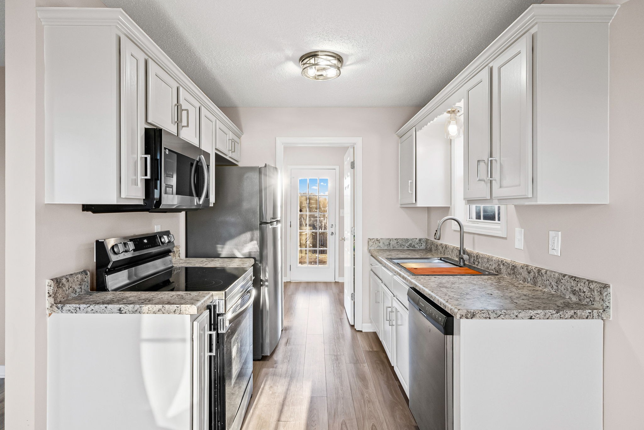 1010 Winesap Road Clarksville, TN 37040 - Photo 6 of 22 a kitchen with stainless steel appliances granite countertop a sink stove and refrigerator