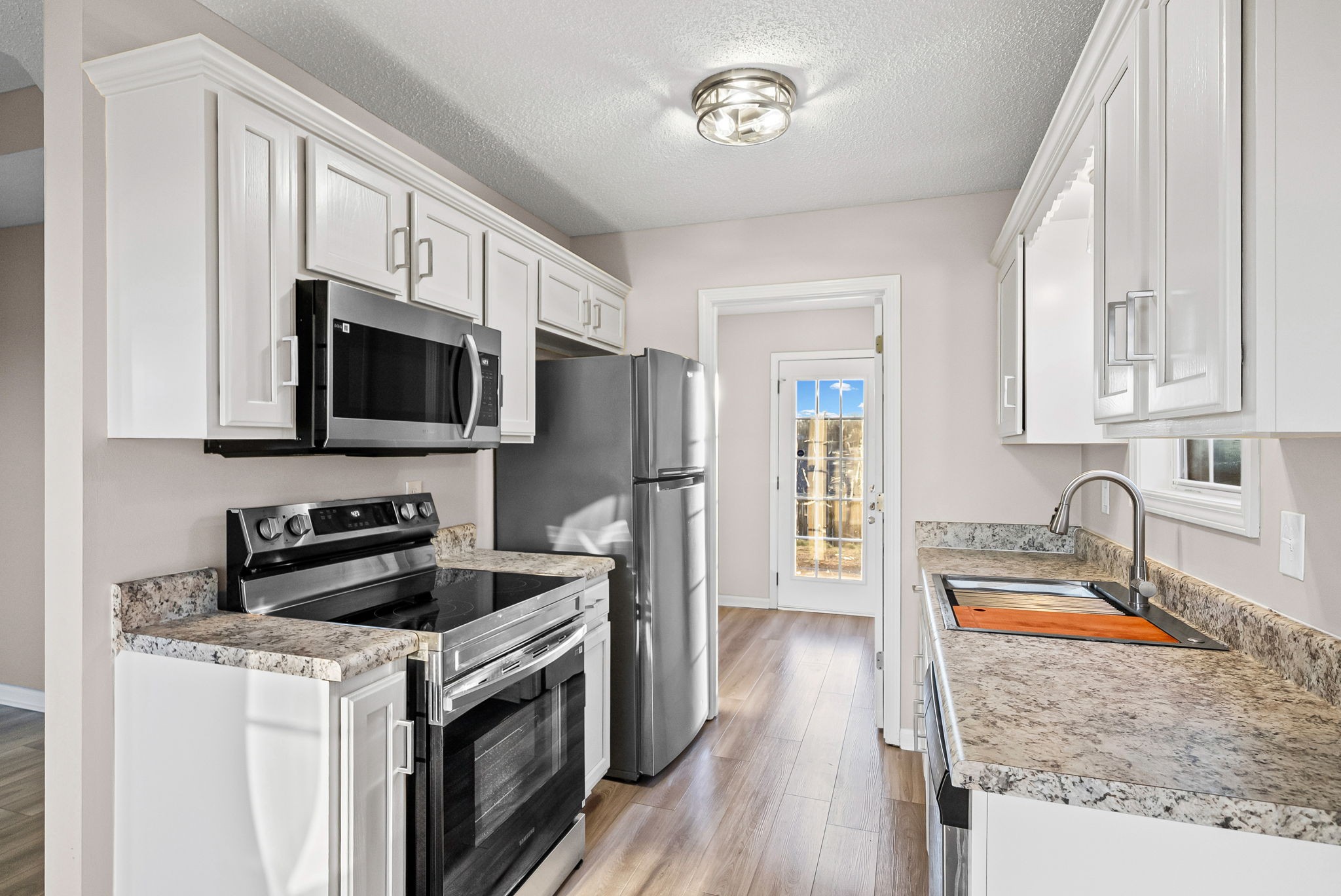 1010 Winesap Road Clarksville, TN 37040 - Photo 7 of 22 a kitchen with a sink stove top oven and refrigerator