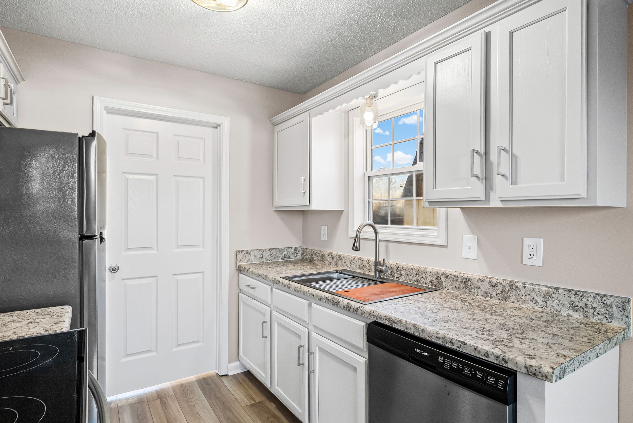 1010 Winesap Road Clarksville, TN 37040 - Photo 10 of 22 a kitchen with stainless steel appliances granite countertop a sink stove and refrigerator