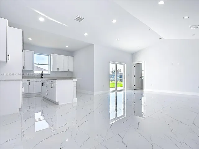 a kitchen with white cabinets