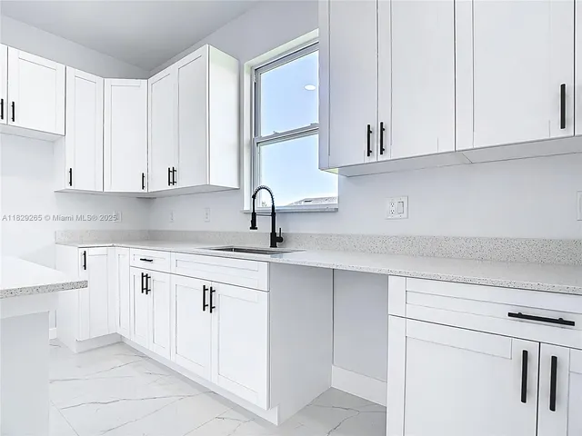 a kitchen with stainless steel appliances a refrigerator and cabinets